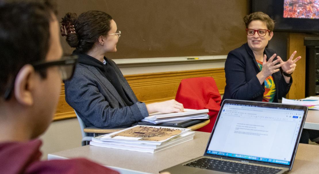 two women talking and a man on a computer